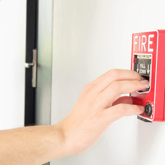 man-is-reaching-his-hand-push-fire-alarm-hand-station